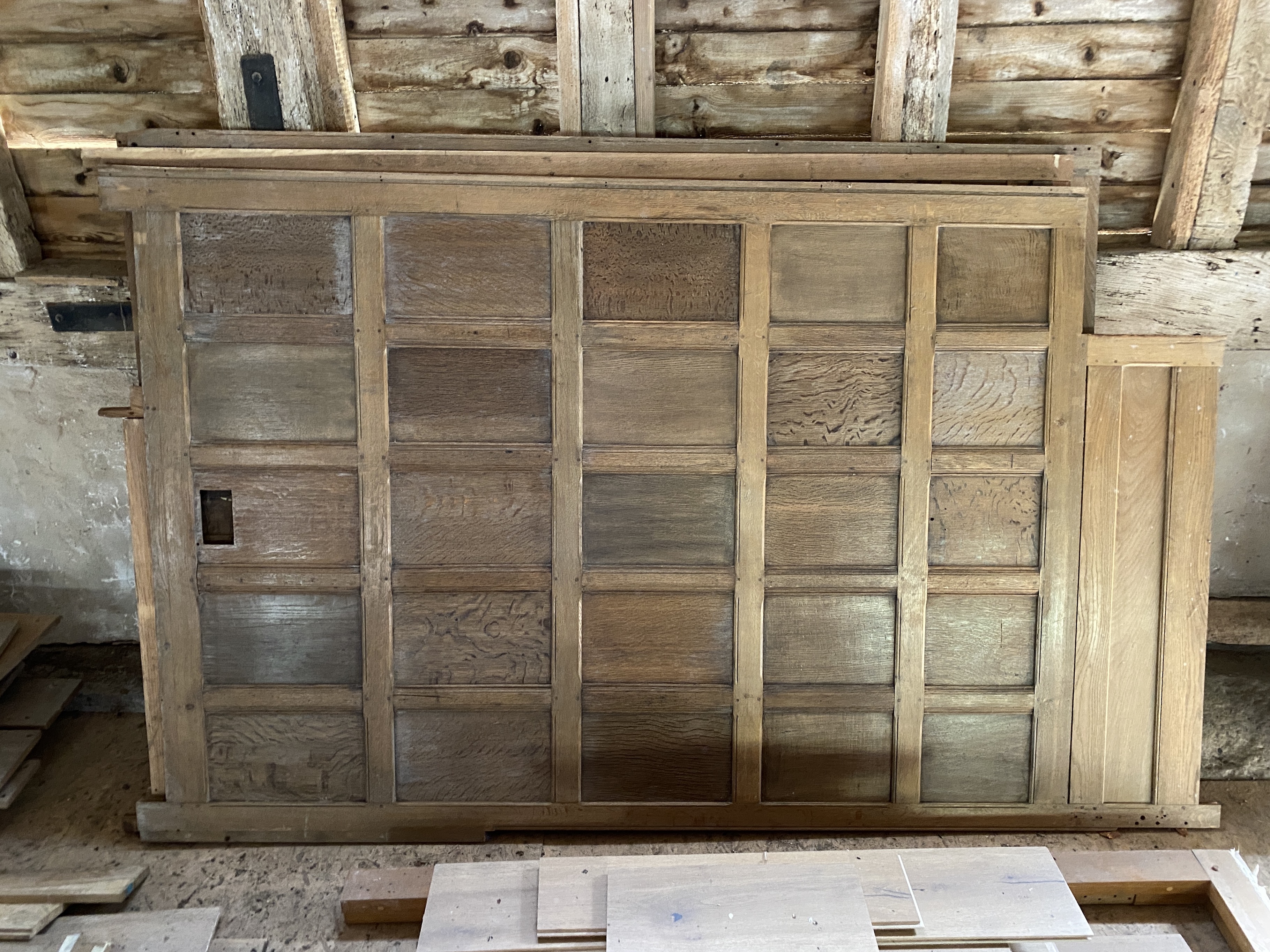 Oak panelling formerly in the library at Plumpton Place, as fitted to three walls in the room measuring, 585cm and two each of 440cm, individual sections of 192 x 72cm (the secret door); 258 x 110cm; 255 x 132cm; 260 x 1